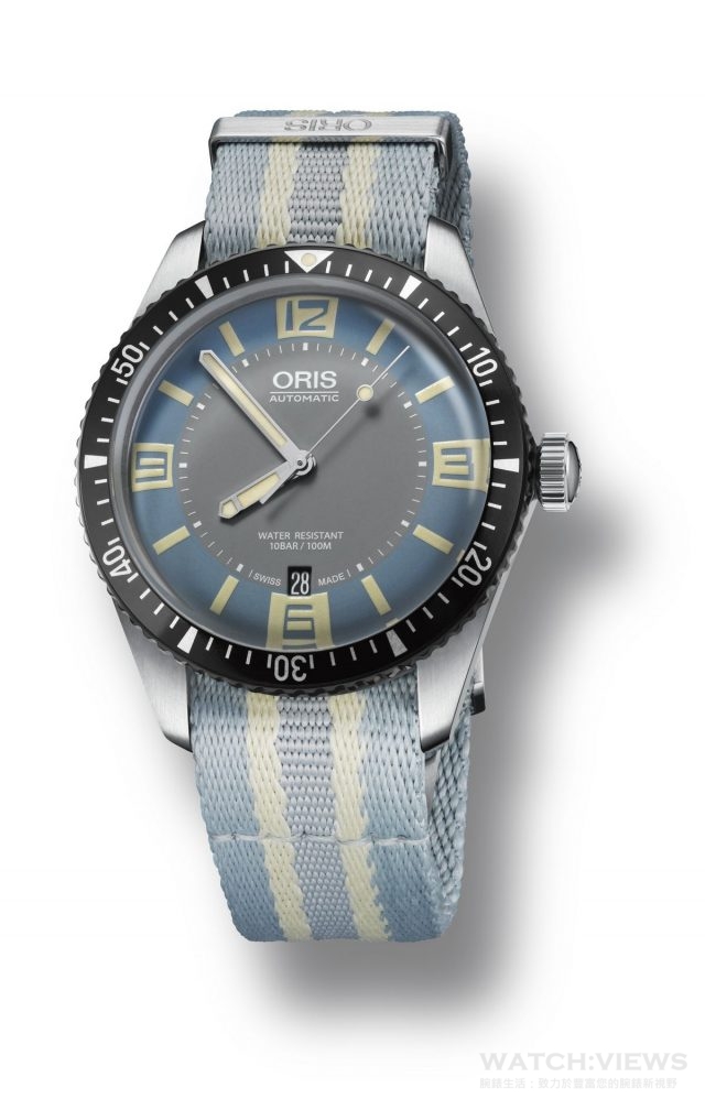 Swiss watch manufacturer Oris launches its new Divers Sixty-Five with a two-tone grey and light “Deauville” blue dial option. Its dial design is inspired by 1960s colour palette, particularly the styles of upmarket French seaside resort of Deauvil